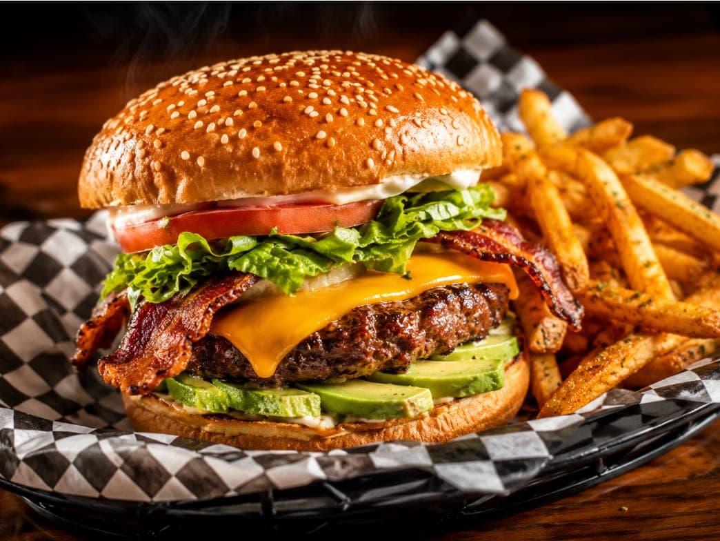 The California Burger with avocado, bacon and cheddar cheese, served with fries.