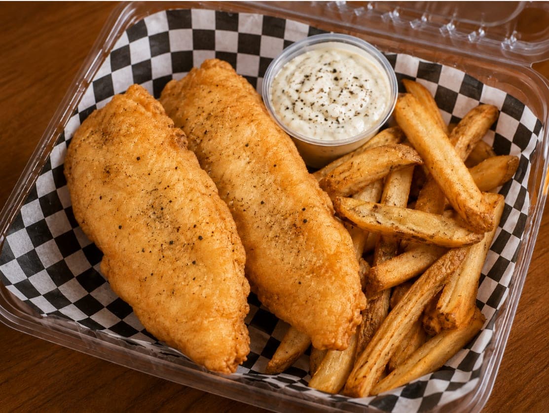 Two battered fish fillets with fries and a side of tartar sauce.