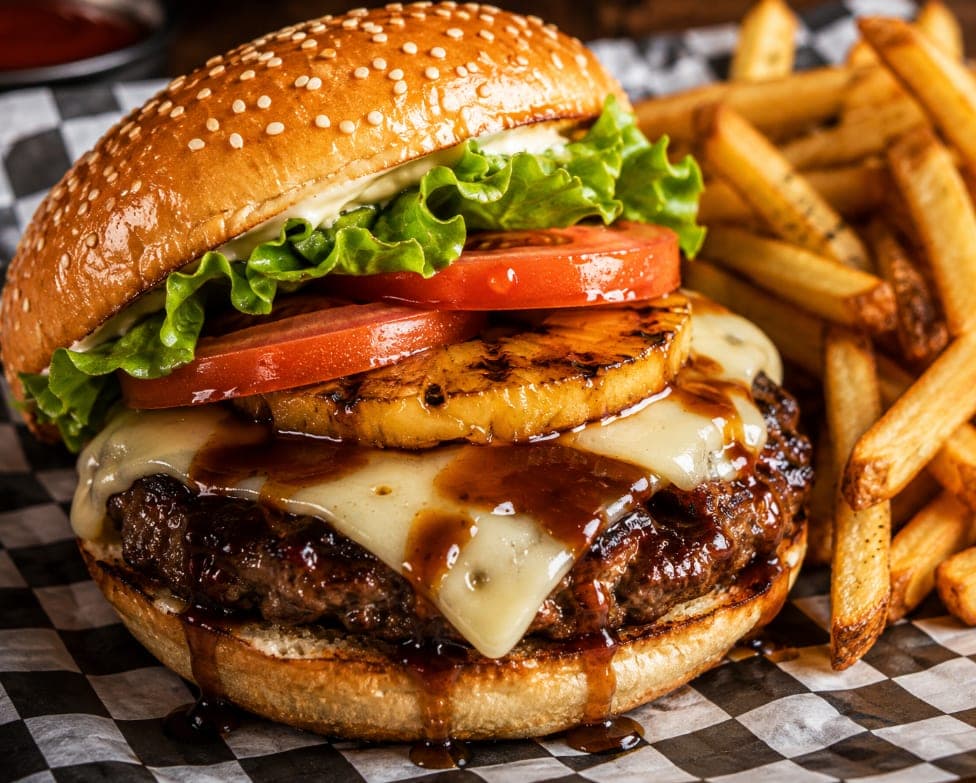 The Hula Burger with grilled pineapple, swiss cheese and teriyaki sauce, served with fries.