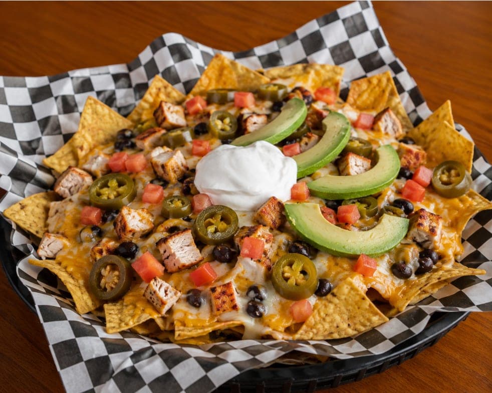 Chips under melted cheese, grilled chicken, black beans, jalapenos, avocado, tomato and sour cream.
