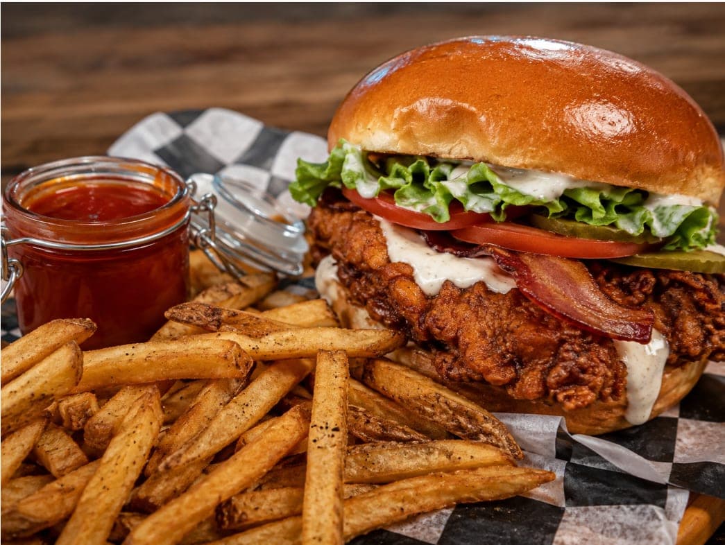 The Original Wicked chicken sandwich with lettuce, tomato, pickles, bacon and ranch, served with fries.