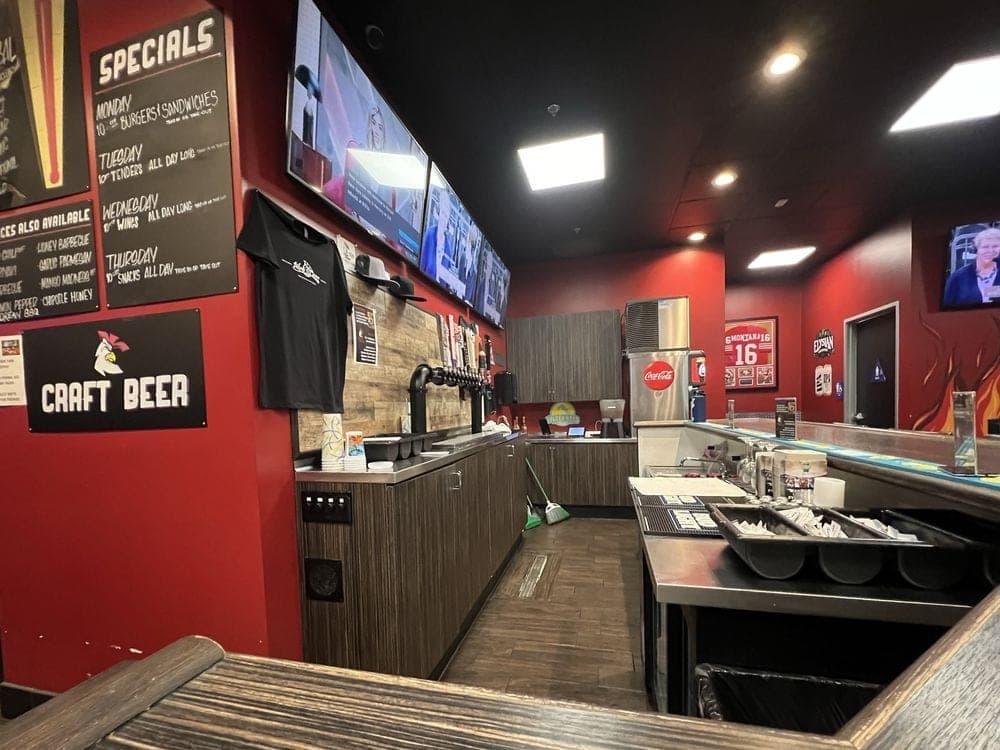 The order counter under the craft beer taps and the TV wall.